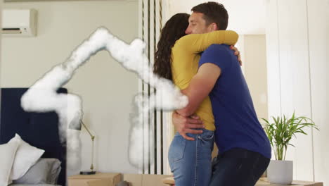 Animation-of-cloud-house-icon-over-happy-diverse-couple-embracing-in-new-home