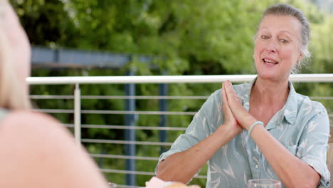 Senior-Caucasian-woman-gestures-during-a-conversation-outdoors