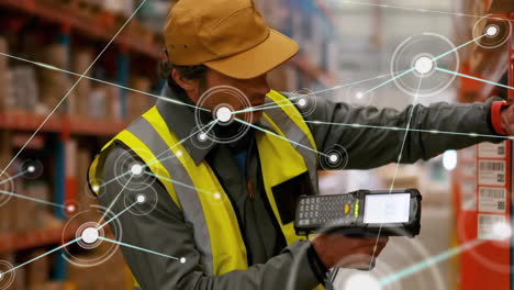 Animation-of-communication-network-over-caucasian-male-worker-using-scanner-at-warehouse