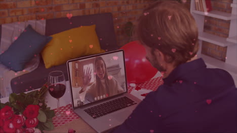 Animation-of-hearts-falling-over-caucasian-man-having-video-call-with-caucasian-woman
