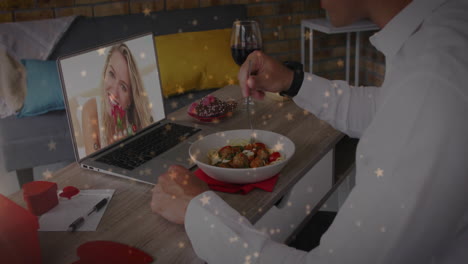 Animation-of-hearts-falling-over-caucasian-man-eating-pasta-having-video-call-with-caucasian-woman