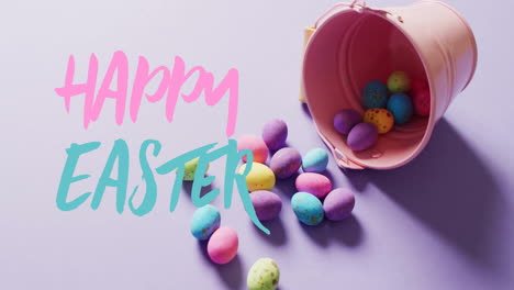 Animation-of-happy-easter-text-over-colourful-easter-eggs-on-purple-background