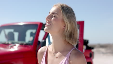 A-young-Caucasian-woman-enjoys-the-sunshine-outdoors-on-a-road-trip