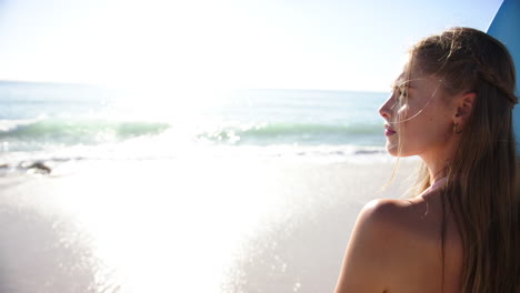 A-young-Caucasian-woman-gazes-at-the-ocean-horizon-with-copy-space