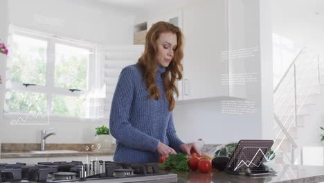Animation-of-digital-data-processing-over-caucasian-woman-using-tablet-and-chopping-vegetables