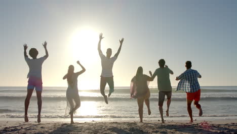 Diverse-friends-jump-joyfully-on-a-sunny-beach