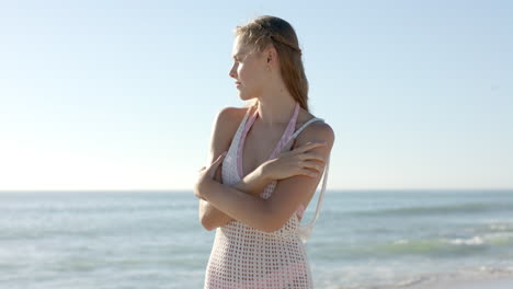 Young-Caucasian-woman-stands-on-a-sunny-beach