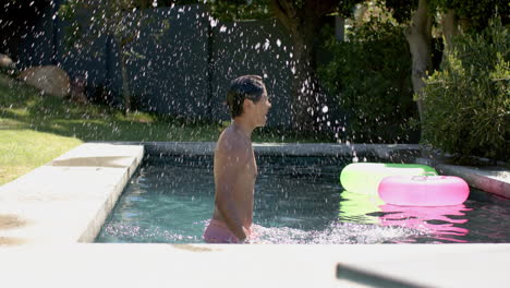 Teenage-Asian-boy-enjoys-a-sunny-day-at-an-outdoor-pool