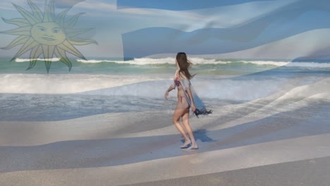 Animation-of-flag-of-uruguay-over-caucasian-woman-at-beach
