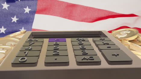 Animation-of-dollar-coins-and-calculator-over-flag-of-usa