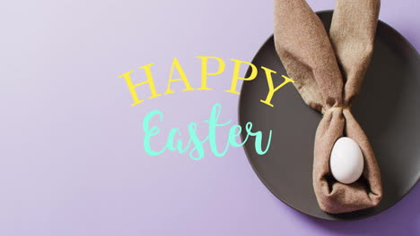 Animation-of-happy-easter-text-over-white-easter-egg-in-cloth-on-purple-background