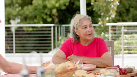Senior-biracial-woman-enjoys-a-meal-outdoors