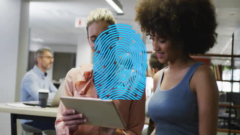 Animation-of-blue-fingerprint-over-diverse-colleagues-talking-in-creative-office
