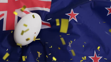 Animation-of-confetti-over-white-rugby-ball-and-flag-of-new-zealand
