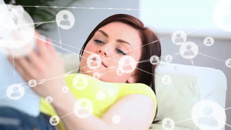 Animation-of-network-of-connections-with-people-icons-over-caucasian-woman-using-tablet