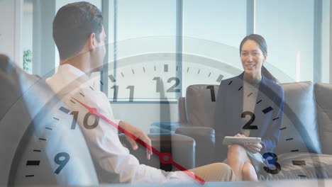 Animation-of-clock-moving-over-diverse-colleagues-talking-in-office