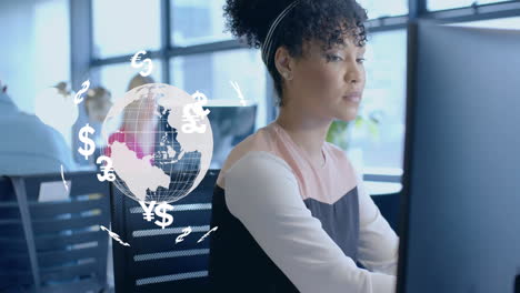 Animation-of-currency-icons-and-globe-over-biracial-woman-using-computer