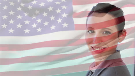Animation-of-flag-of-usa-over-caucasian-businesswoman-smiling