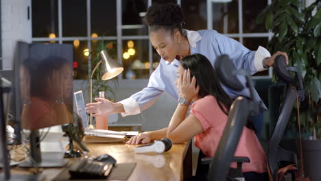 Young-African-American-businesswoman-assists-biracial-woman-in-office