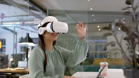 Asian-woman-explores-virtual-reality-in-a-modern-office-setting