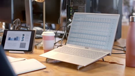 A-laptop-displays-a-detailed-business-budget-spreadsheet-in-an-office-setting