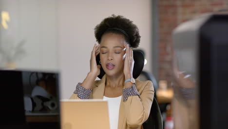 A-young-African-American-woman-looks-stressed-at-her-business-office-desk