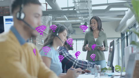 Animation-of-wifi-icons-and-data-processing-over-diverse-business-people-in-office