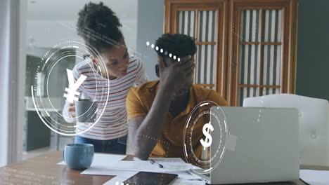 Animation-of-currency-icons-data-processing-over-worried-african-american-couple-paying-bills