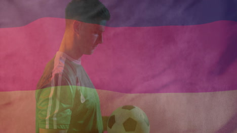 Animation-Der-Flagge-Deutschlands-über-Einem-Kaukasischen-Männlichen-Fußballspieler-Mit-Ball