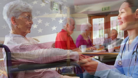 Animation-of-flag-of-usa-over-caucasian-female-doctor-with-senior-patient-in-wheelchair