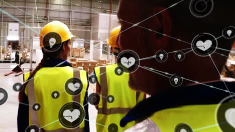 Animation-of-network-of-connections-with-icons-over-diverse-workers-walking-in-warehouse