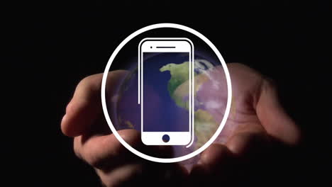 Animation-of-smartphone-icon-over-hands-holding-globe-on-black-background