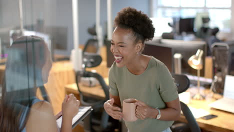 Young-African-American-woman-shares-a-laugh-in-the-business-office