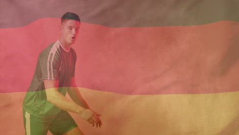 Animation-of-flag-of-germany-over-caucasian-male-football-player-kicking-ball