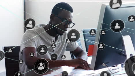 Animation-of-network-of-connections-with-people-icons-over-african-american-businessman-in-office