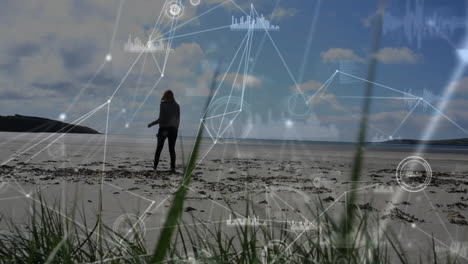 Animation-of-network-of-connections-with-data-processing-over-caucasian-woman-walking-on-beach