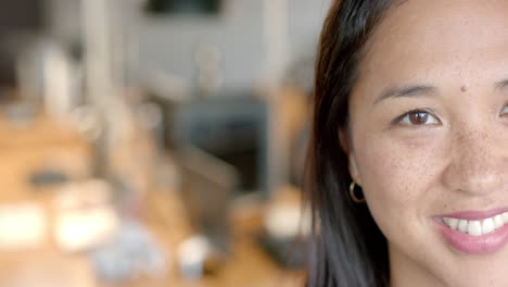 Close-up-of-an-Asian-businesswoman-smiling-at-the-camera,-with-copy-space