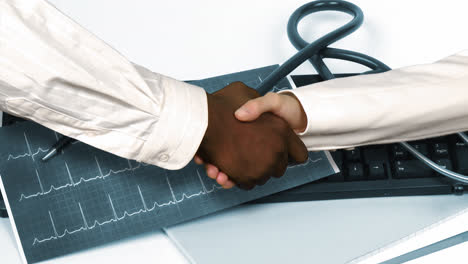 Animation-of-doctors-shaking-hands-against-a-hospital-office