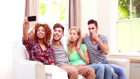 Happy-friends-taking-selfie-on-the-sofa