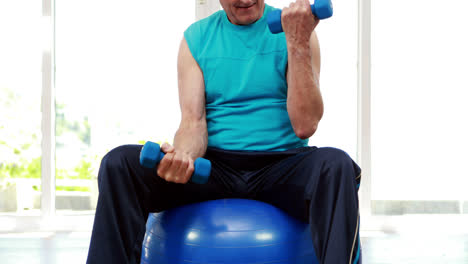 Senior-man-sitting-on-exercise-ball