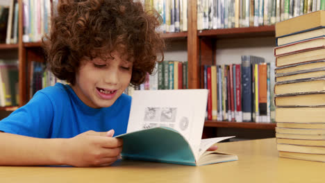 Smiling-little-boy-reading-a-book