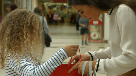 Daughter-showing-her-mother-shopping-bag