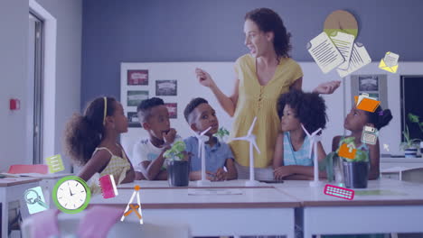 Animation-of-school-icons-over-diverse-female-teacher-with-schoolchildren-in-classroom
