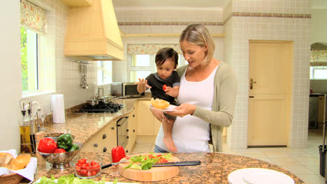 Woman-with-son-in-her-armsin-kitchen