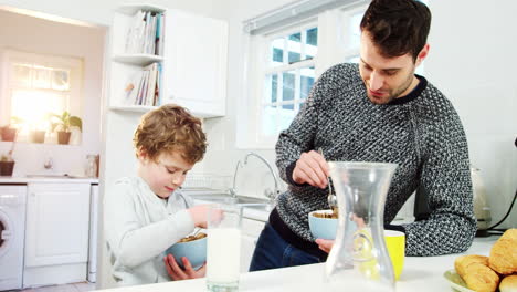 Father-and-son-having-a-breakfast-in-kitchen