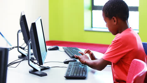 Schoolboy-using-computer-in-classroom