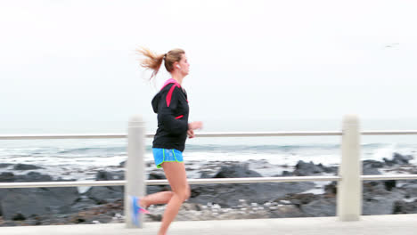 Pretty-young-determined-woman-running-
