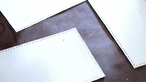 Craftswoman-arranging-leather-piece-on-work-tool