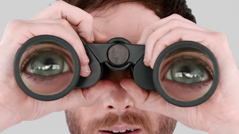 Man-looking-through-binoculars-