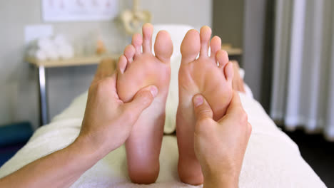 Physiotherapist-giving-foot-massage-to-a-woman